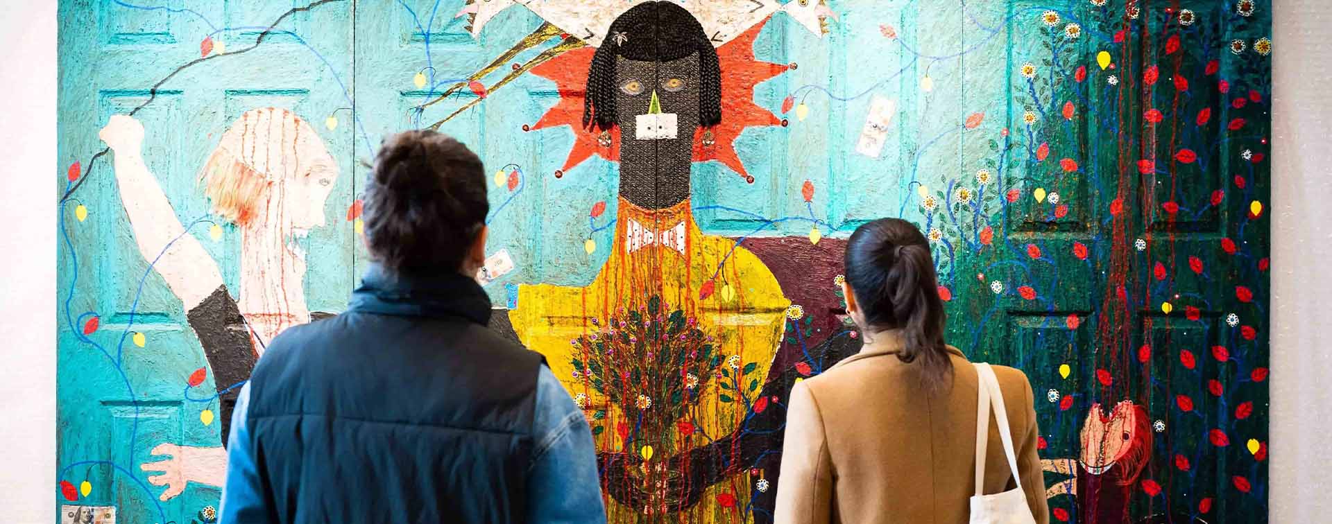 Man and woman looking at a piece of art