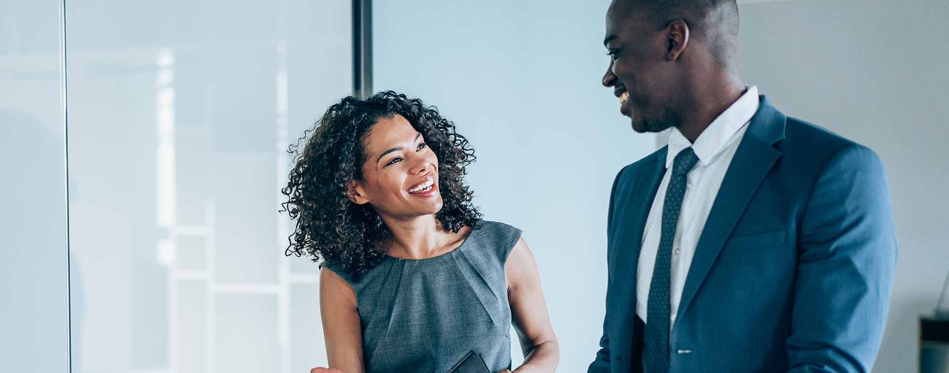 Two colleagues having a discussion in a modern office