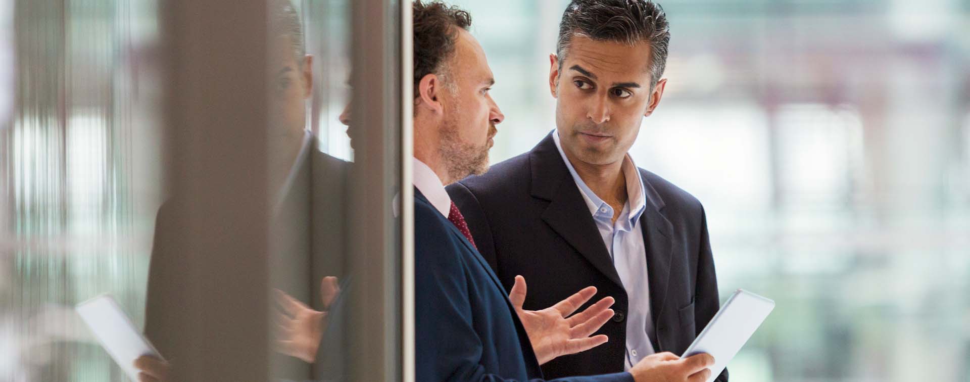 Two businessmen discussing project on the office balcony