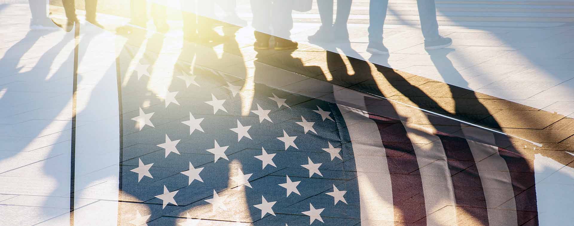 American flag overlayed with a reflection of people walking on a tiled floor.