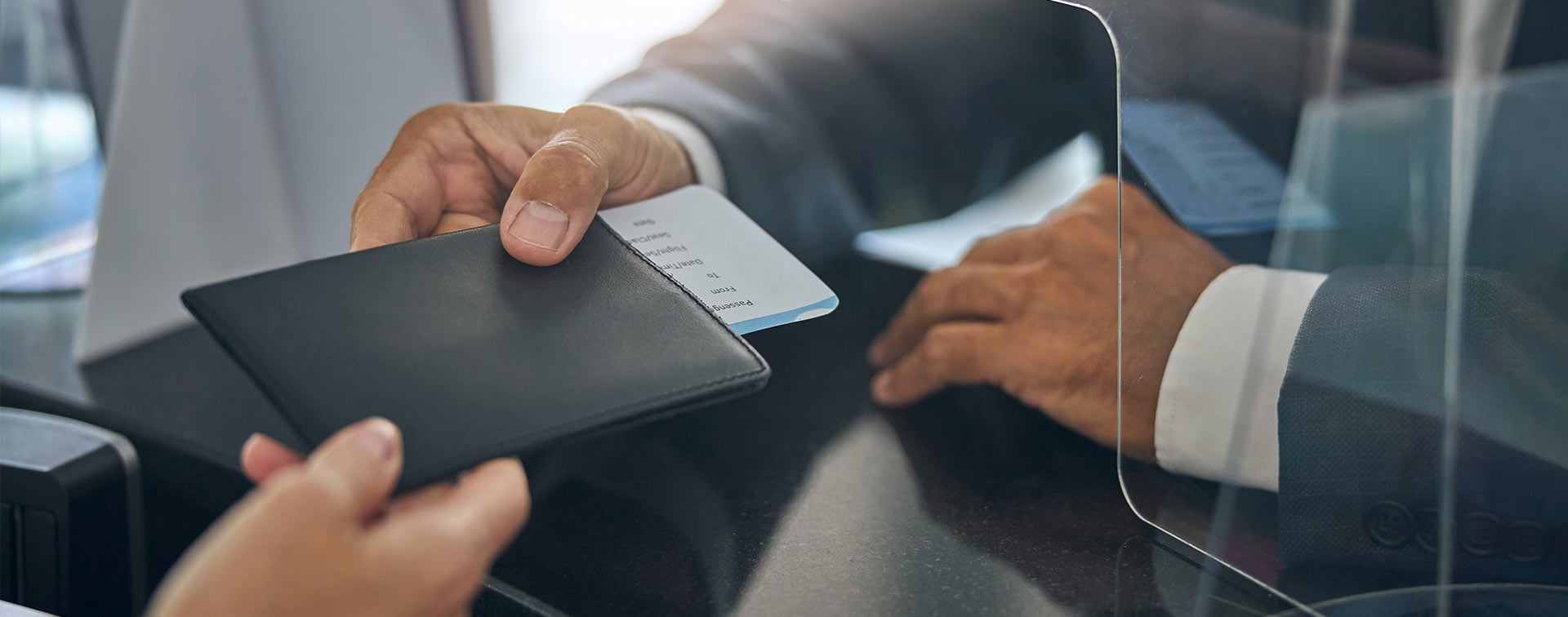 Male in suit checking in before flight