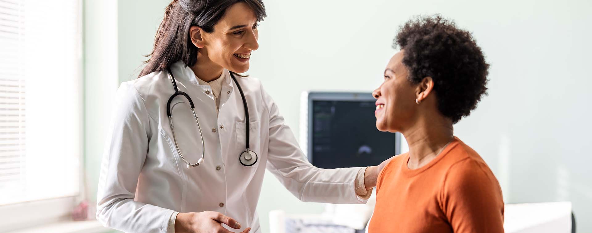 Female medical practitioner reassuring a patient