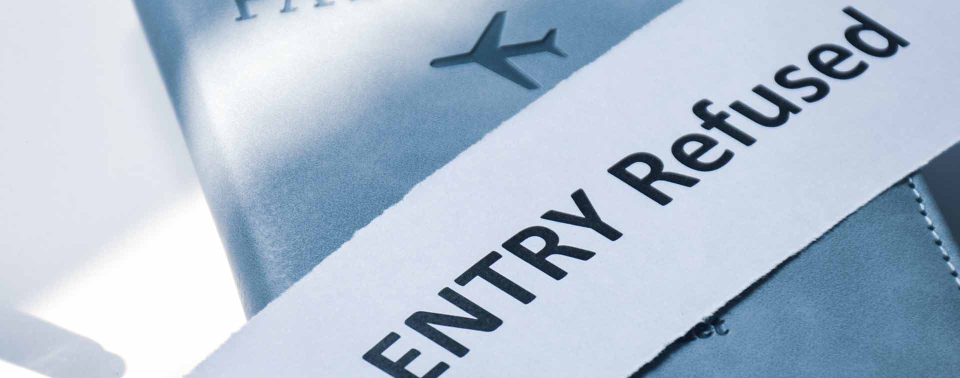 Torn paper with the inscription Entry refused on Passport.