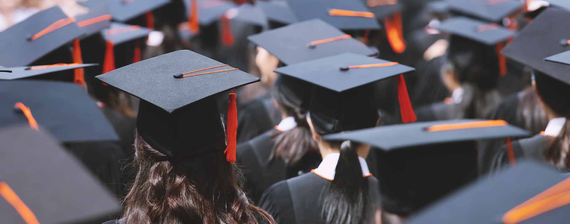 Backside graduation hats during commencement success graduates of the university