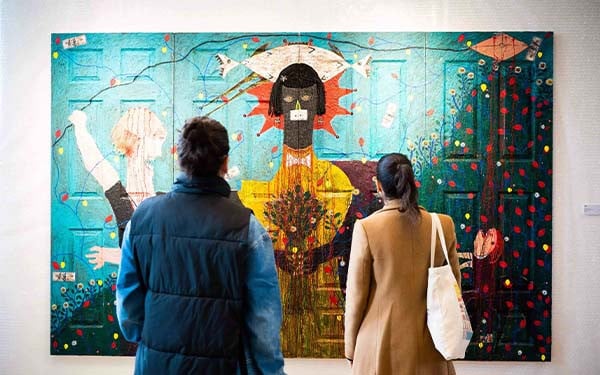 Man and woman looking at a piece of art