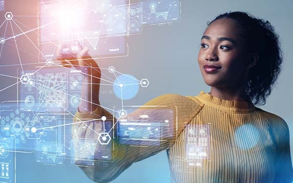 Digital composite of a woman reaching out to touch images of charts