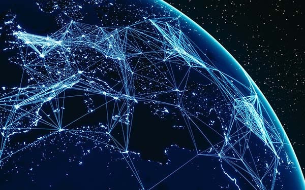 Digital composite of the earth with glowing lines connecting continents