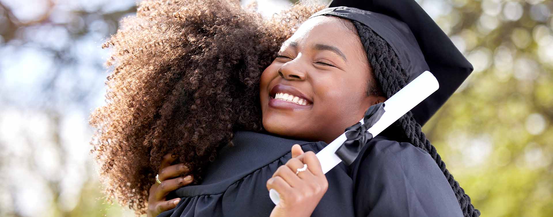 A young woman hugging her friend on graduation day 