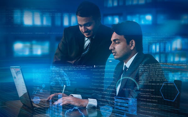 Two Indian businessmen working on a laptop