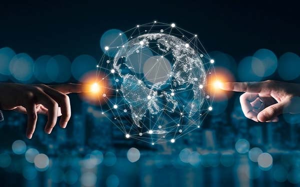 Digital composite image of two hands reaching out with their index fingers to touch a digital globe in the center of the image