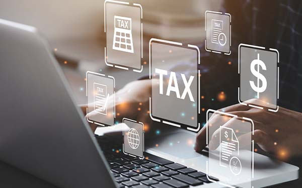 Business person using a computer to complete Individual income tax return form online for tax payment. 