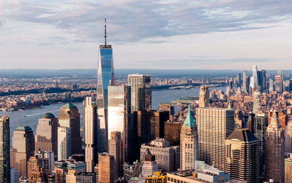 New York City skyline seen from a high angle, featuring the One World Trade Center and the Hudson River 