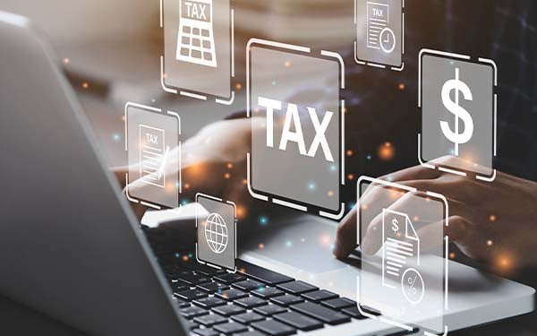 Person filling out tax forms on a laptop