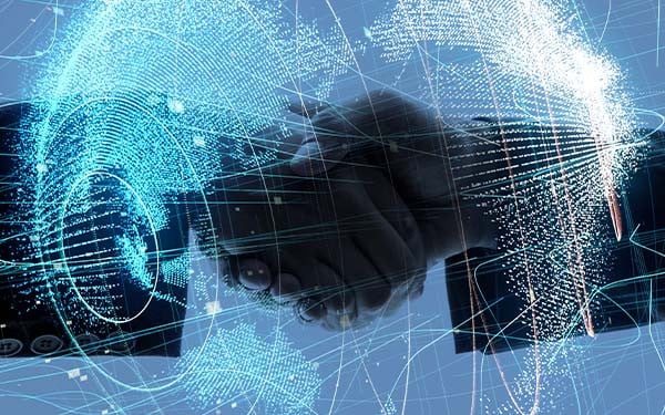 Digital composite of a futuristic rendering of the globe and two people shaking hands